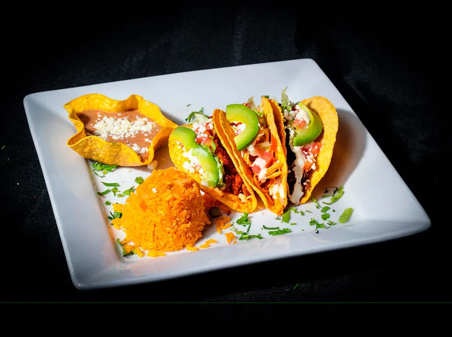 A combination taco plate served at El Progreso
